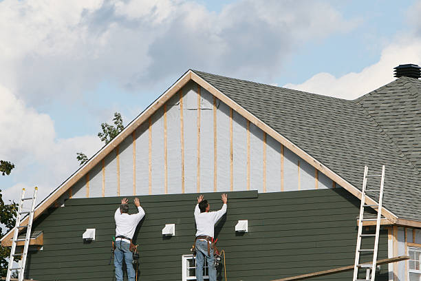 Professional Storm Damage Siding Repair technician working in Elgin, TX